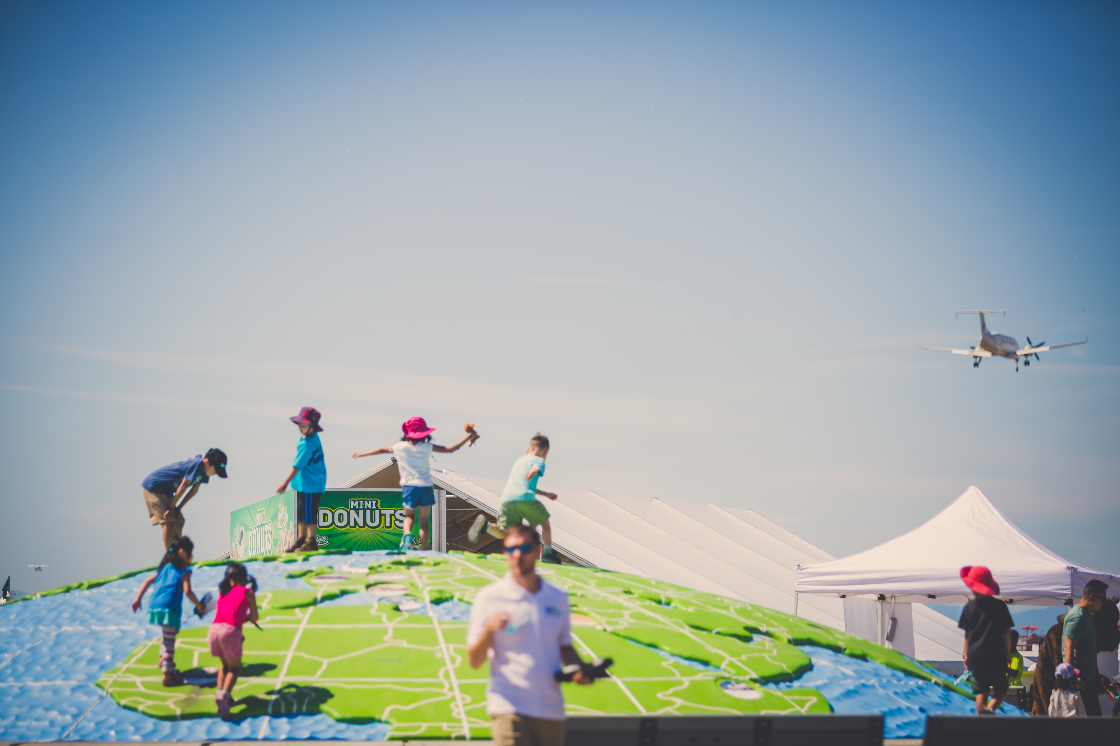 Children playing on top of the globe at Flight Path Park
