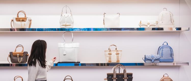 Woman browsing purses in a Duty Free shop