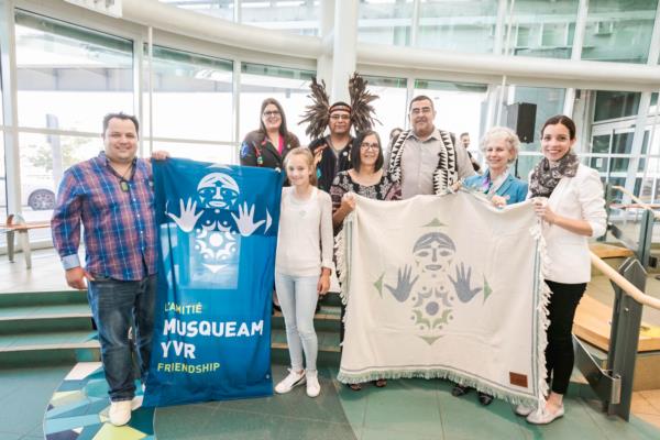 Summer, Thomas and YVR/Musqueam VIPs with new banners