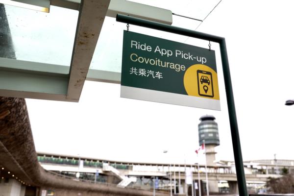 A ride app pick-up sign hangs outside YVR's domestic terminal.