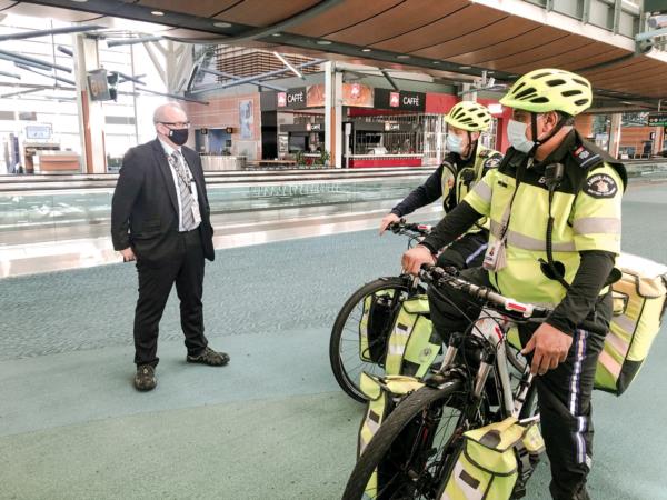 Dan standing in the International Departures Terminal post-security with the bike squad