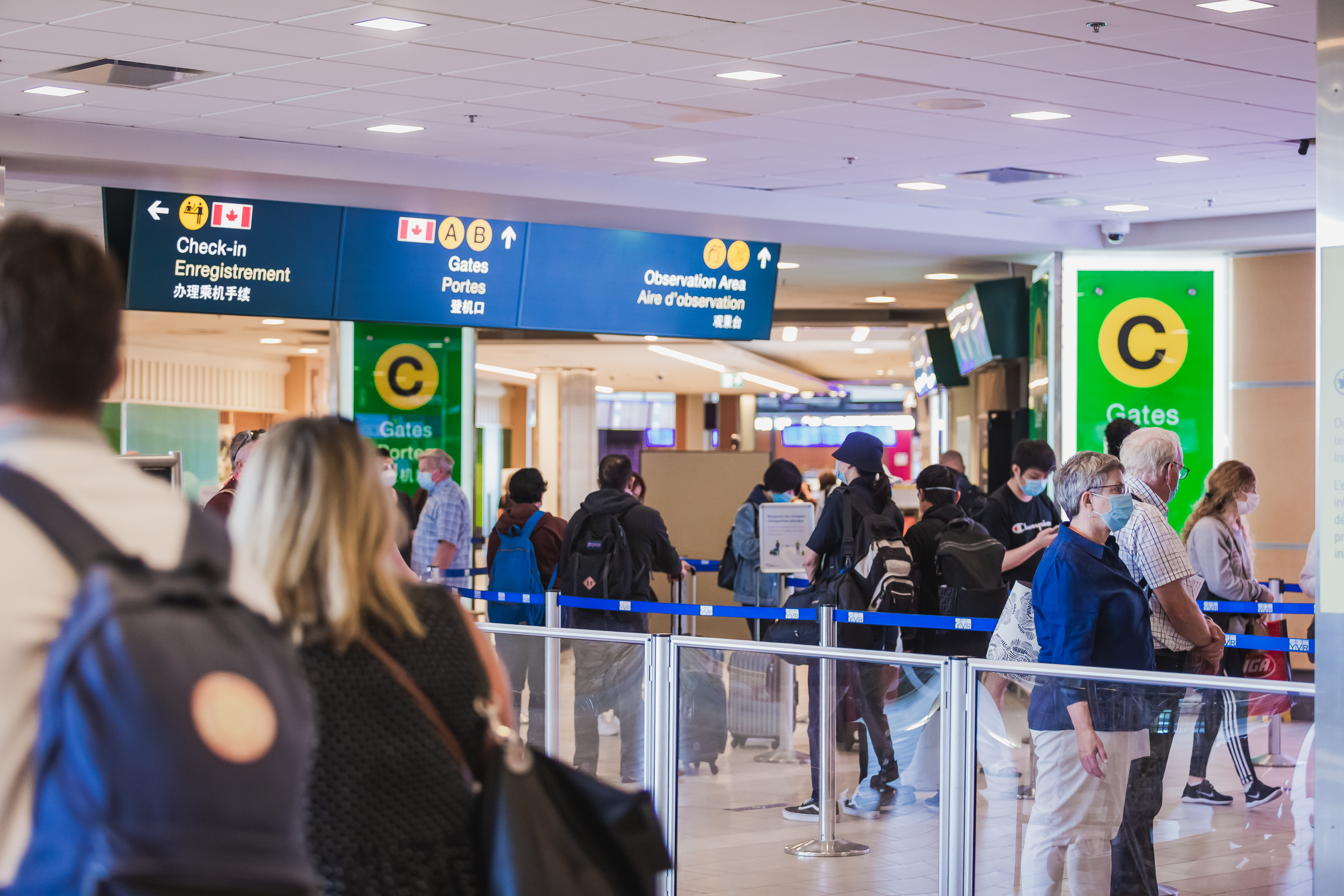 People lining up to go through security screening.