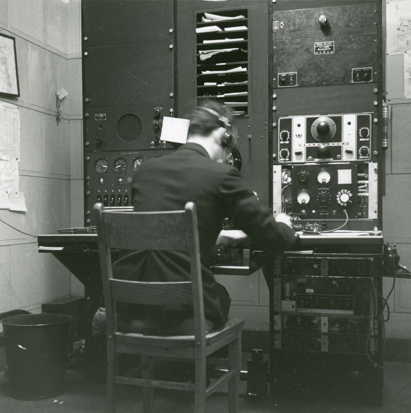 Photo of a man wearing headphones and looking at a dashboard
